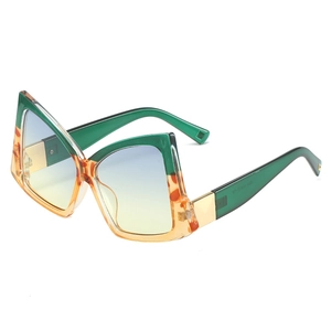 Oversized butterfly bow-shaped sunglasses with green and orange gradient lenses