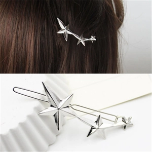 Detailed view of silver star hair clips showing metallic texture on model and still life