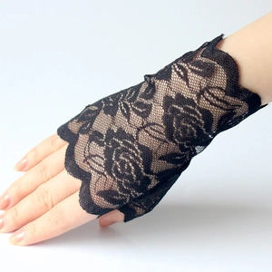 Close-up of black lace fingerless driving gloves with intricate floral rose patterns