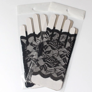 Close-up of black lace fingerless gloves with floral embroidery in clear packaging