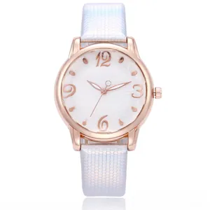 Close-up of rose gold watch featuring a floral dial and light blue honeycomb textured strap