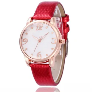 Close-up of red diamond-embossed leather strap and rose gold watch case with floral dial