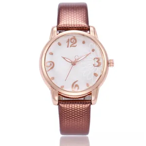 Macro detail of rose gold bezel with floral dial and brown snakeskin leather strap