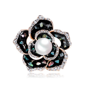 Detail of rose gold guitar brooch with colorful shell inlay and centered pearl