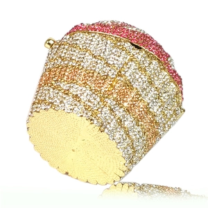 Macro shot of cupcake clutch bottom with golden metal base and sparkling rhinestones