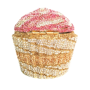 Detailed close-up of cupcake clutch evening bag with pink and white rhinestones