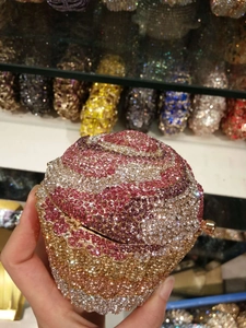 Detailed macro view of the sparkling rhinestone texture on cupcake evening clutch bag