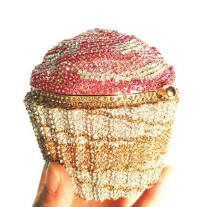 Macro shot of cupcake clutch purse with pink and gold crystal rhinestones details