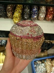 Close-up of cupcake shaped evening clutch with sparkling gold and pink gradient rhinestones