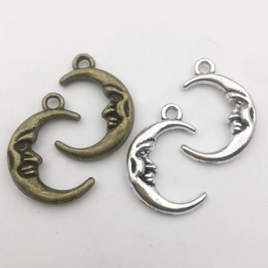 Celestial crescent moon pendants with faces in antique bronze and silver metal alloy