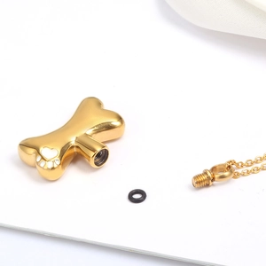 Golden bone cremation pendant for pets with paw print and screw-open mechanism