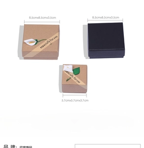 Macro view of kraft and black gift boxes for jewelry with sizes and floral decor