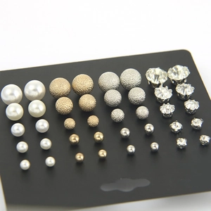 Set of 12 pairs of pearl, matte metal ball, and crystal stud earrings on black card