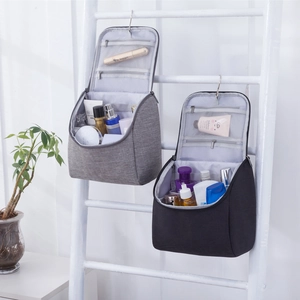 Hanging toiletry bags in grey and black featuring multiple compartments and a metal hook