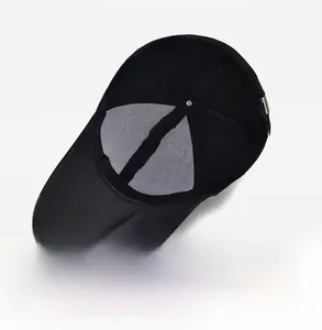Detailed interior view of black canvas baseball cap featuring breathable mesh and metal buckle