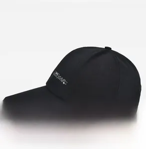 Side view of black canvas baseball cap featuring white CAP 87 print and grey brim detail