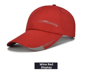 Detail of a wine red sports baseball cap with side print and long curved brim