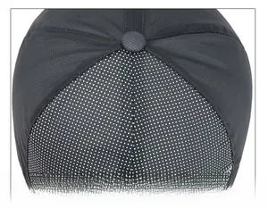 Detailed top view showing precise stitching and grid texture on a black sun hat