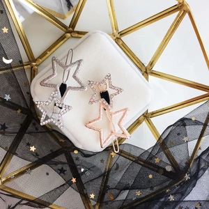 Macro detail of silver and rose gold star hair clips with sparkling crystal rhinestones
