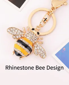 Macro shot of bee keychain with crystal rhinestones and yellow enamel on gold plating