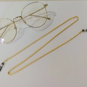 Elegant gold metal glasses chain with anti-slip rubber loops on white background