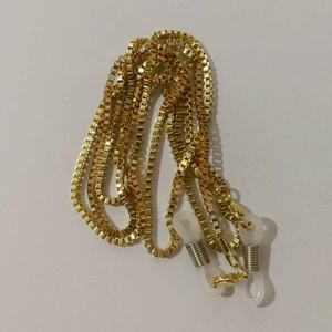 Detail of golden box chain with white silicone anti-slip loops for glasses and masks