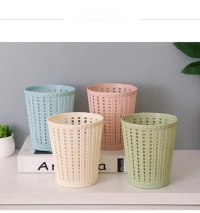 Close-up of hollow woven texture storage bins in four pastel colors on a desktop