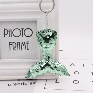 Detailed view of green reversible sequin mermaid tail keychain with polished metal ring