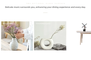 White ceramic vases with matte texture and hollow circle design on a wooden tabletop