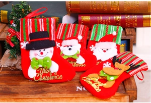 Detail of Christmas stockings with Santa and snowman embroidery in a cozy home setting