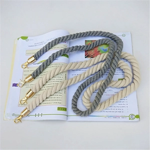 Detail of twisted cotton rope straps in grey and beige with gold metal lobster clasps