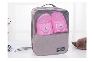 Detail view of a waterproof travel shoe bag with mesh window and carry handle