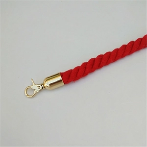 Detail of red braided barrier rope with premium golden metal snap hook and end cap