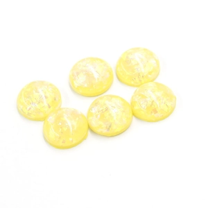 Detail of 12mm yellow resin oval synthetic opal stones with glitter flakes