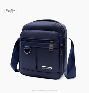 Side view of dark blue waterproof oxford cloth shoulder bag with multiple zip pockets