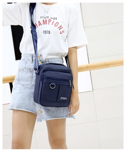 Detail of navy blue waterproof Oxford cloth shoulder bag with adjustable fabric strap
