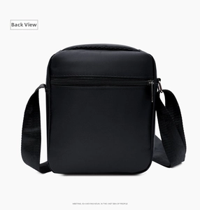 Detail view of the black Oxford shoulder bag featuring a rear zipper pocket and adjustable strap