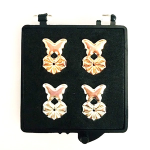 Macro shot of 2 pairs of butterfly earlobe lifters in gold and silver metal finishes