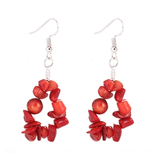 Detail view of handmade red gravel stone earrings with silver hooks in a triangle shape