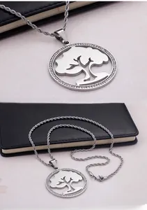 Detailed view of silver tree of life pendant with sparkling crystals and twisted rope chain