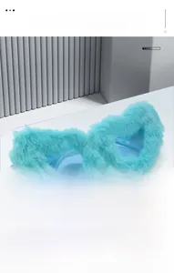 Detail of light blue heart-shaped sunglasses with soft faux fur trim on minimalist steps
