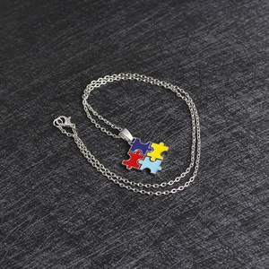 Detail of four-color puzzle pendant necklace for best friends with silver metal chain