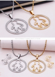 Detail of round pendant and earrings set with crystal inlay in gold and silver finish