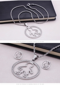 Detail of silver titanium steel jewelry set with round crystal boy pendant and earrings