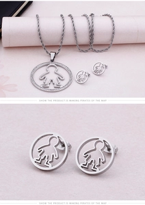 Macro shot of silver titanium steel necklace and teddy bear stud earrings set