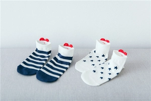 Detail of navy blue striped and star pattern cotton ankle socks with red heel accents