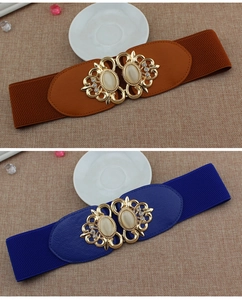 Close-up of elastic waist belt featuring gold alloy buckle and cat-eye stones