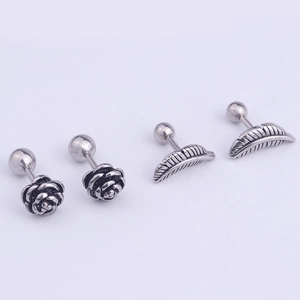 Detail view of vintage stainless steel rose and feather stud earrings set in silver