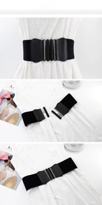 Detail of wide black elastic belt with double oval metal buckle for women dresses