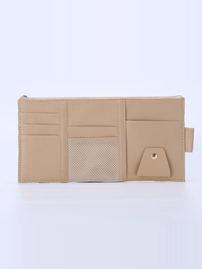 Detailed close-up of beige car sun visor organizer featuring card slots and mesh pocket